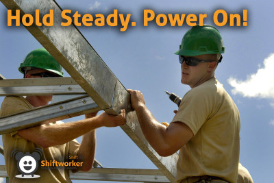 Shiftworker construction workers in hard hats handling a ladder safely, demonstrating teamwork and sustained energy.
