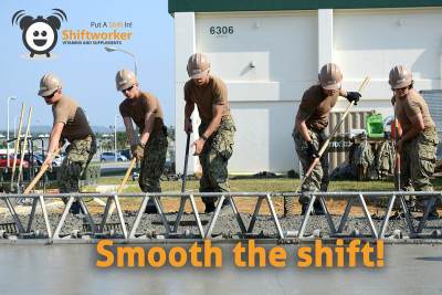 Shiftworker construction workers smoothing wet concrete with rakes, maintaining focus and endurance on a demanding site.